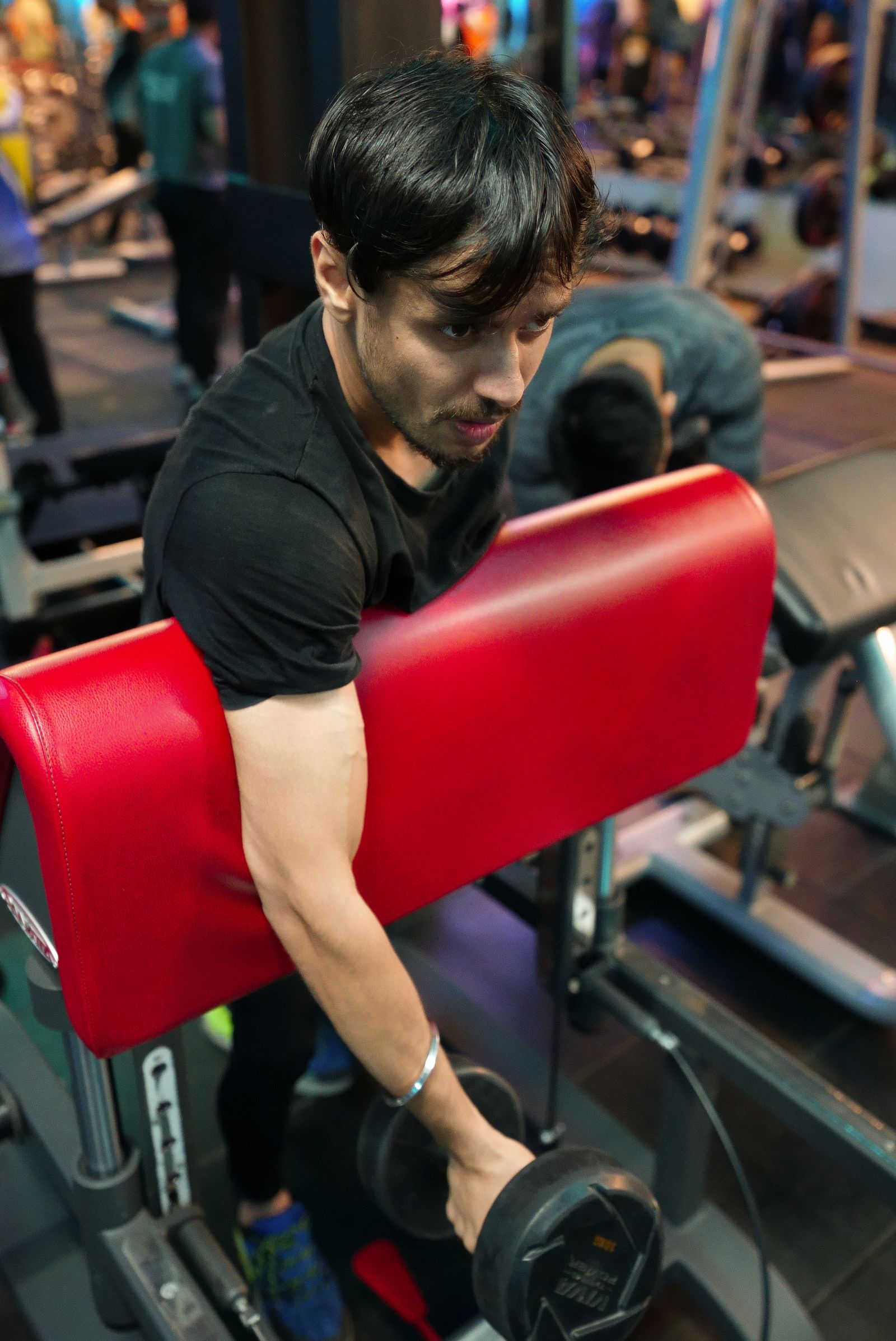 A young man working out with weights in a gym