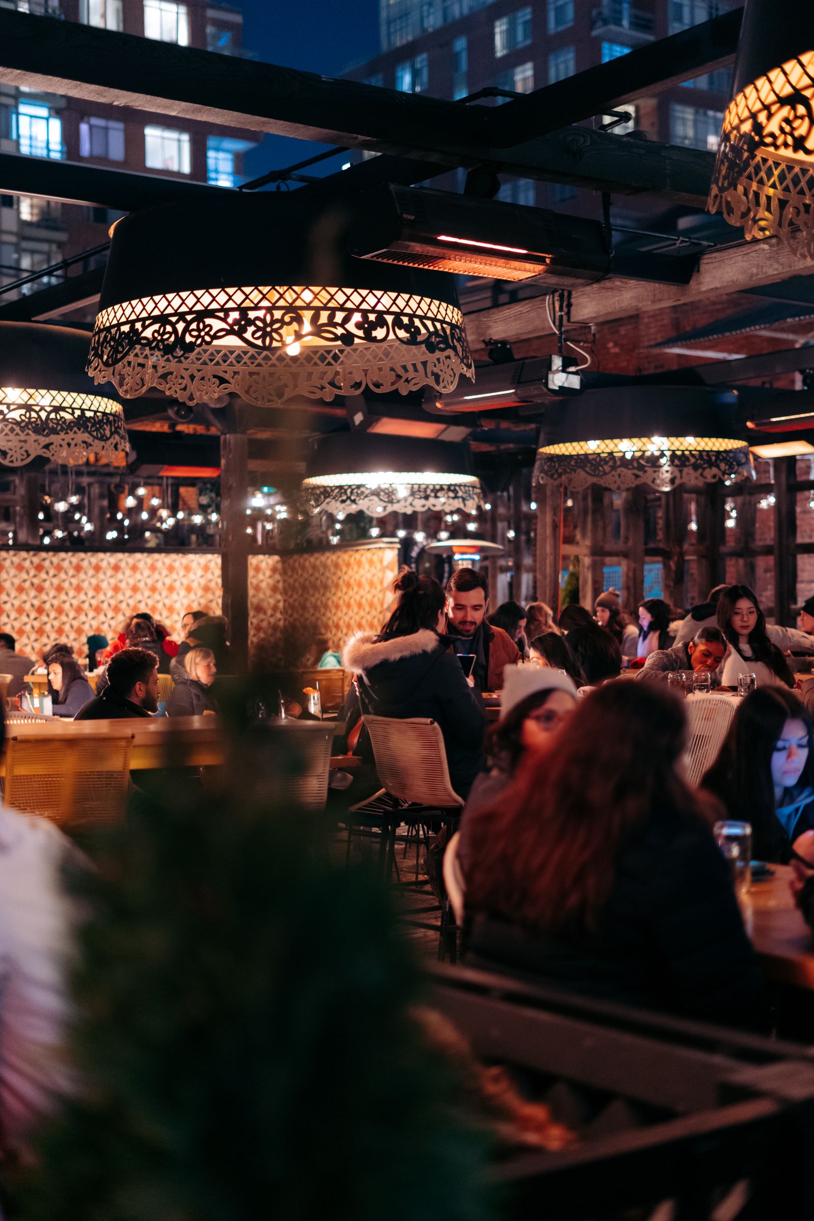 People dining in a lively restaurant at night